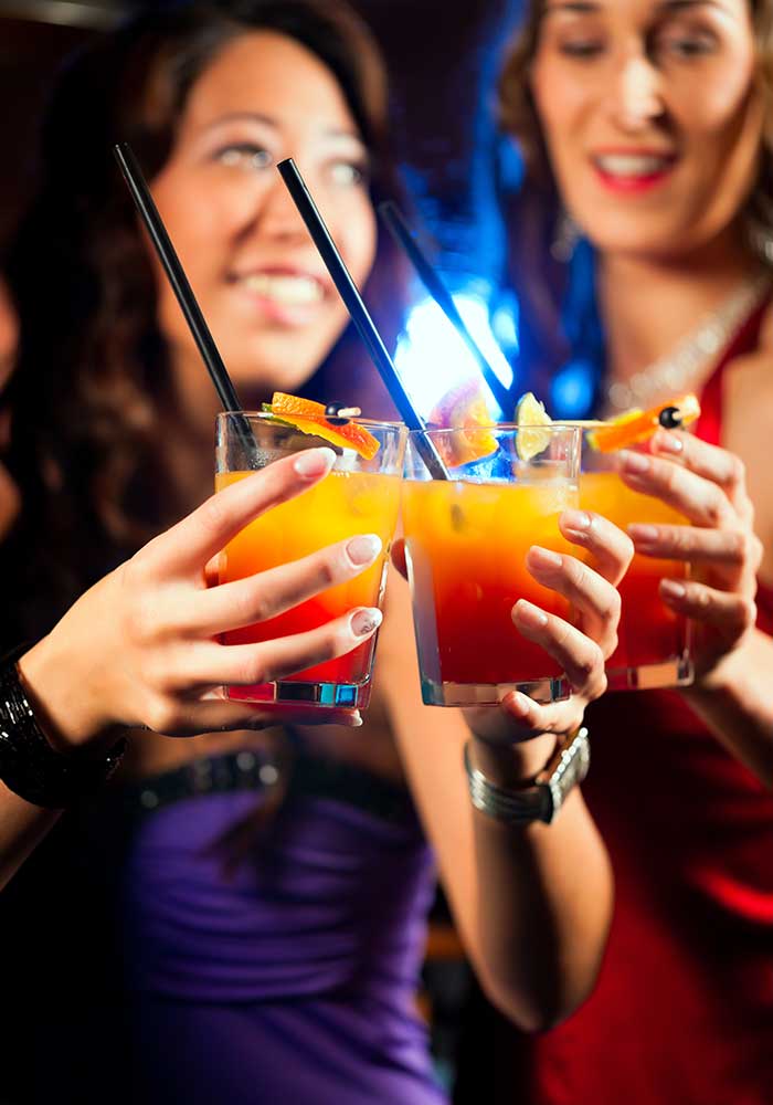 Leute mit Cocktails in Bar oder Club